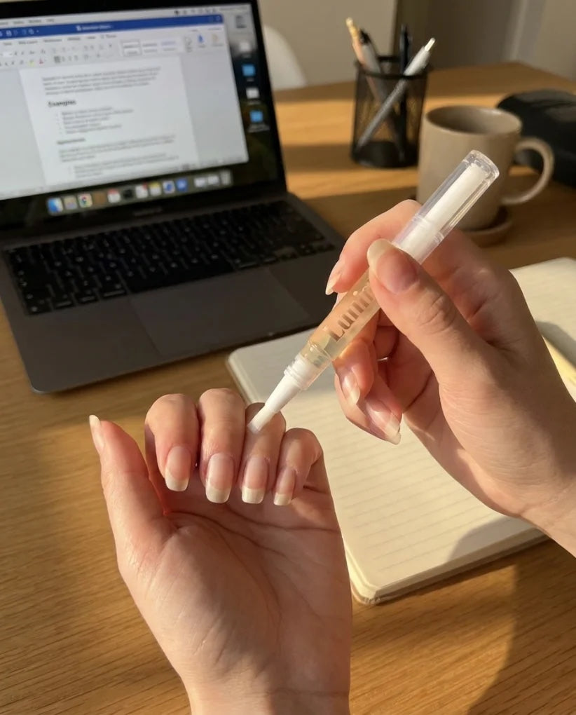 Applying the Lumina Beauty nail oil pen at my desk, the fifteen-second swap